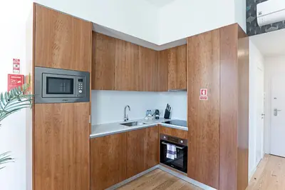 a kitchen with a sink and a microwave at Monte dos Judeus 26 by LovelyStay in Porto
