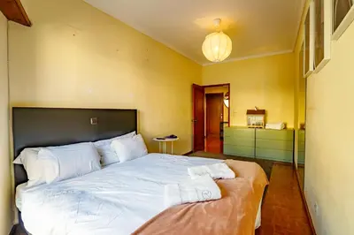a bedroom with a large bed with white sheets at Porto Central Home in Porto