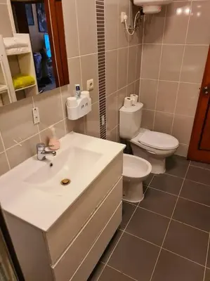 a bathroom with a sink and a toilet at Porto Central Home in Porto