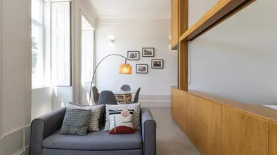 a living room with a couch and a chair at OPOrto Downtown Studio by LovelyStay in Porto
