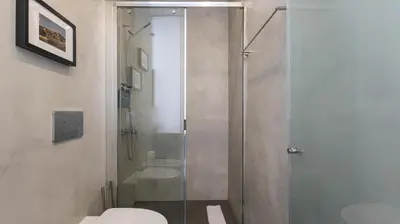 a shower with a glass door in a bathroom at OPOrto Downtown Studio by LovelyStay in Porto