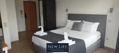 a hotel room with a bed with swans on it at New Life - PALÁCIO CRISTAL STUDIO-3F in Porto