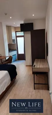 a bedroom with a bed and a wooden bench at New Life - PARQUE CIDADE STUDIO-0T in Porto