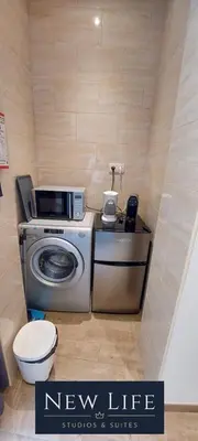 a bathroom with a washing machine and a toilet at New Life - PARQUE CIDADE STUDIO-0T in Porto