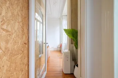 a hallway with a door open to a room at GuestReady - Bolhão Market Place in Porto