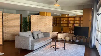 a living room with a couch and a tv at BEST - Studio Porto Downtown with AC and Parking in Porto