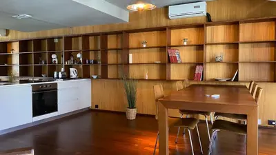 a kitchen with a table and a dining room at BEST - Studio Porto Downtown with AC and Parking in Porto