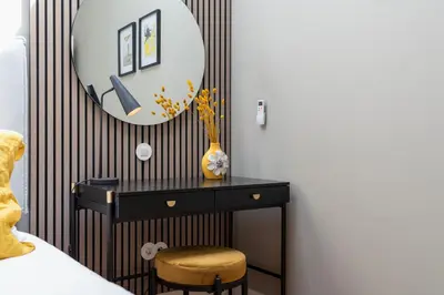a bedroom with a black dresser and a mirror at The Mouzinho Penthouse in Porto