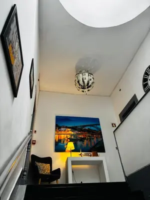 a stairway with a room with a painting on the wall at Douro sunset lounge in Porto