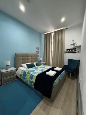 a bedroom with a large bed and a chair at Douro sunset lounge in Porto