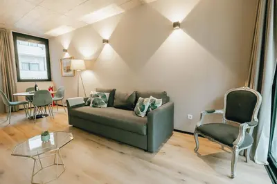 a leather couch with pillows in a living room at City Center Premium Apartment by Vacationy in Porto