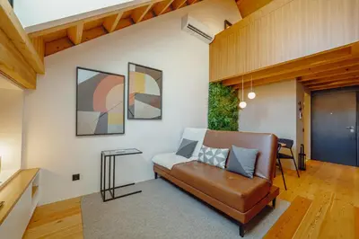a living room with a leather couch and a table at Elegant Downtown Apartment by Vacationy in Porto