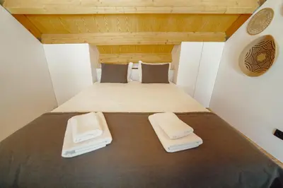 a small room with a bed with two pillows at Elegant Downtown Apartment by Vacationy in Porto