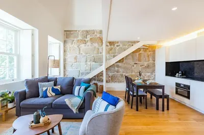 a living room with a couch and a table at Porto Loft Living in Porto