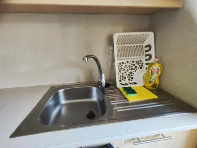 a kitchen sink with a faucet and a detergent at T0 no centro do Porto in Porto