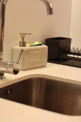 a bathroom with a sink and a shower and a toilet at Casa da Trindade in Porto