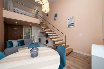 a living room with a table and a staircase at Paraíso Apartment by Amber Star Rent in Porto