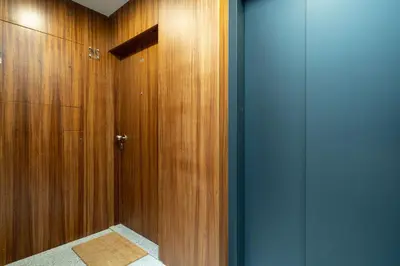 a bathroom with wood paneled walls and a shower at Paraíso Apartment by Amber Star Rent in Porto