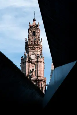 a tall clock tower with a clock on it at Casa Girasol River View in Porto