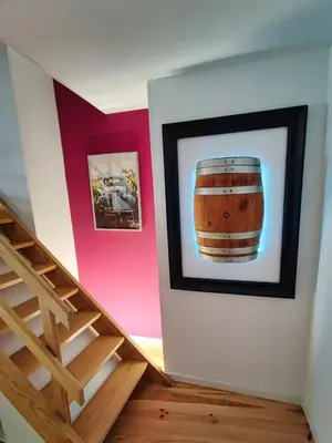 a painting of a barrel on a wall next to a staircase at WLoft in Vila Nova de Gaia