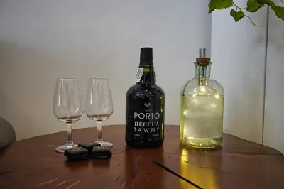 a bottle of wine and two wine glasses on a table at WLoft in Vila Nova de Gaia
