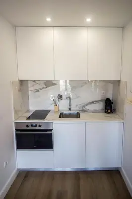 a kitchen with white cabinets and a sink at Guest H4U - Porto Bonfim Heroismo in Porto