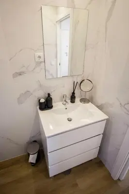 a white bathroom with a sink and a mirror at Guest H4U - Porto Bonfim Heroismo in Porto