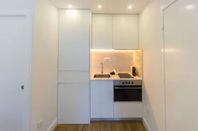 a kitchen with white cabinets and a sink at Guest H4U - Porto Bonfim Heroismo in Porto