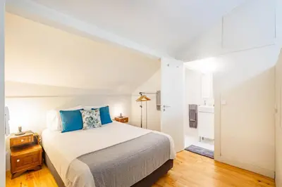 a kitchen and dining room with a white table and chairs at Oporto Loft with Mezzanine in Porto