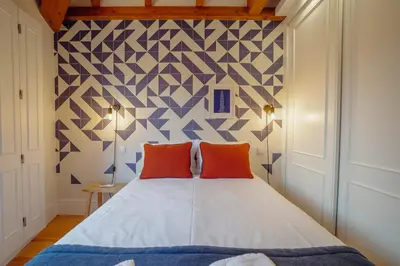 a bedroom with a bed with two orange pillows at Downtown Prime With Terrace by Vacationy in Porto