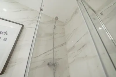 a shower with a glass door in a bathroom at Downtown Prime With Terrace by Vacationy in Porto