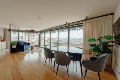a dining room with a table and chairs at Downtown Penthouse With River View by Vacationy in Porto