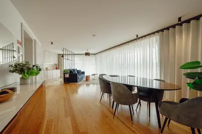 a dining room with a table and chairs at Downtown Penthouse With River View by Vacationy in Porto