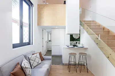 a living room with a couch and a kitchen at Cozy House w/ AC near metro by LovelyStay in Porto