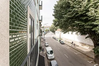 a city street with cars parked on the side of a building at Lapa Flat in City Center by LovelyStay in Porto