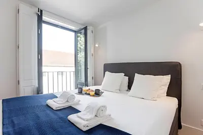 a bedroom with a bed with towels on it at Lapa Flat in City Center by LovelyStay in Porto
