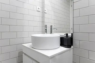 a white bathroom with a sink and a counter at Lapa Flat in City Center by LovelyStay in Porto