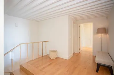 a room with a staircase with a bench and a table at Liiiving in Gaia - Douro Dream View in Vila Nova de Gaia