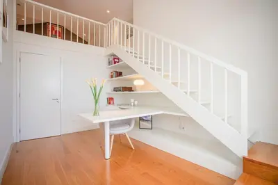 a white staircase in a room with a desk at Liiiving in Gaia - Douro Dream View in Vila Nova de Gaia