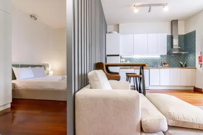 a living room with a couch and a bed at Bonjardim Deluxe Loft in Porto