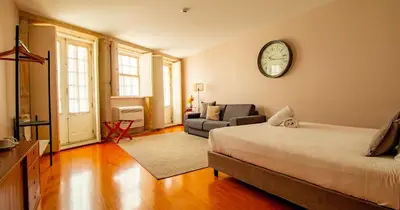 a bedroom with a large bed with a blue blanket on it at ALIBI by YoursPorto in Porto