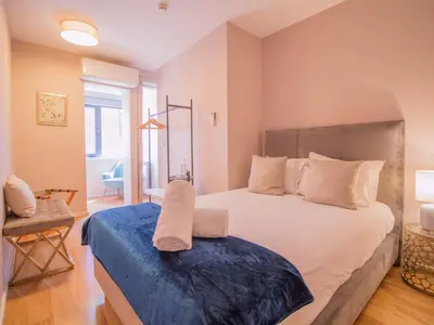 a bedroom with a bed and a chair and a desk at ALIBI by YoursPorto in Porto