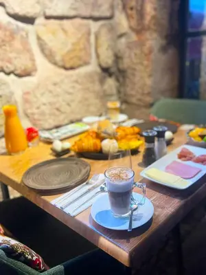a wooden table with plates of food on it at ALIBI by YoursPorto in Porto