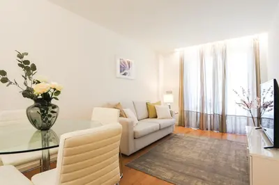 a living room with a couch and a glass table at HM - Casa Ghiselini Porto 214 in Porto