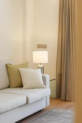 a living room with a white couch and a lamp at HM - Casa Ghiselini Porto 214 in Porto