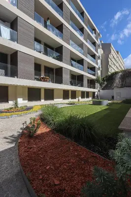 a large apartment building with a lawn in front of it at HM - Casa Ghiselini Porto 214 in Porto