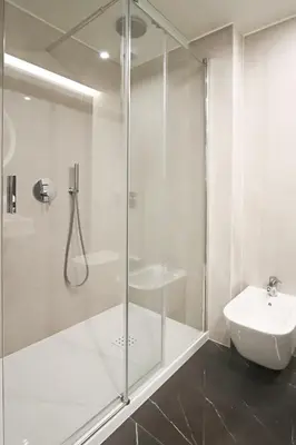 a bathroom with a glass shower and a sink at HM - Casa Ghiselini Porto 214 in Porto