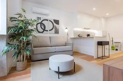 a living room with a couch and a table at Downtown Wonder Flat w/ AC by LovelyStay in Porto