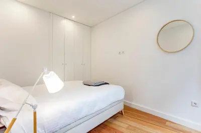 a white room with a bed and a mirror at Downtown Wonder Flat w/ AC by LovelyStay in Porto