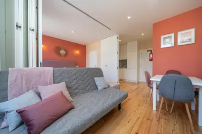 a living room with a couch and a table at Firmeza Apartment by Amber Star Rent in Porto